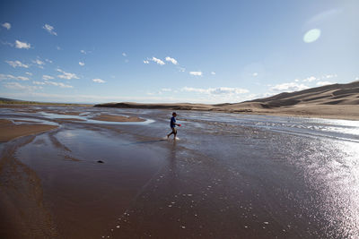 Boy walking at beach