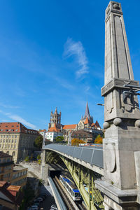 Buildings in city against blue sky