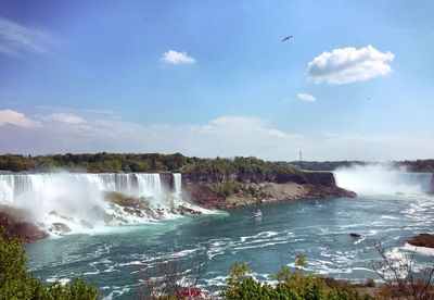 Scenic view of niagara falls against sky