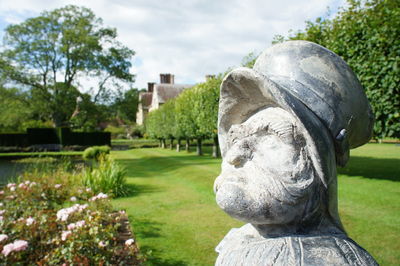 Close-up of statue in park against sky