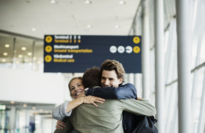 Affectionate business colleagues embracing at airport