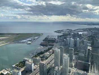 High angle view of river and buildings against sky