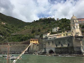 Coastal town against cloudy sky