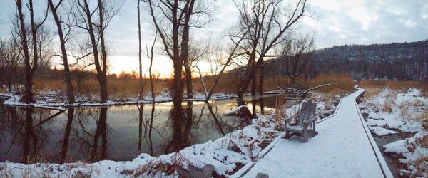 Snow covered landscape with lake in background