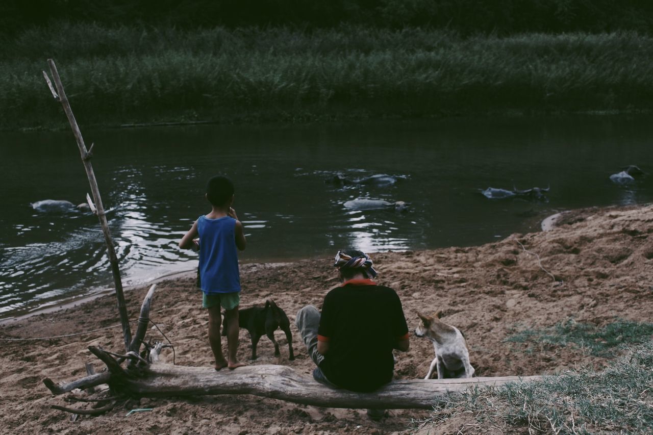 REAR VIEW OF PEOPLE ON SHORE