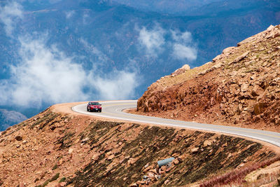 High angle view of red car moving on mountain road