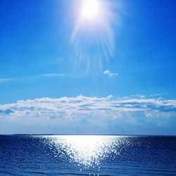 Scenic view of sea against blue sky