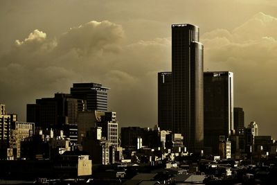Skyscrapers against cloudy sky