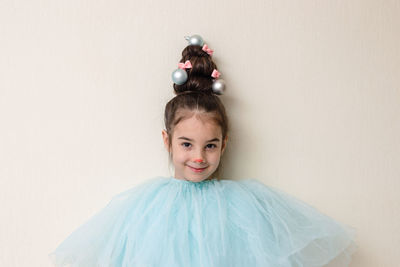 Portrait of funny girl with a hairstyle in the form of a christmas tree