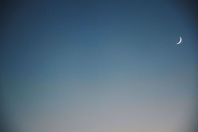 Low angle view of moon in sky at night