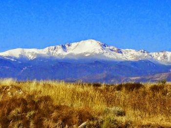 Scenic view of snowcapped mountains against clear sky