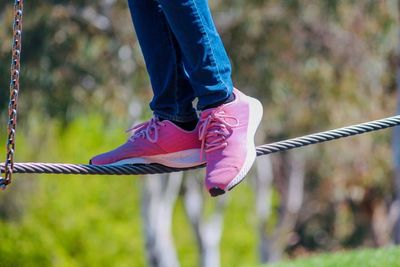 Low section of woman against rope