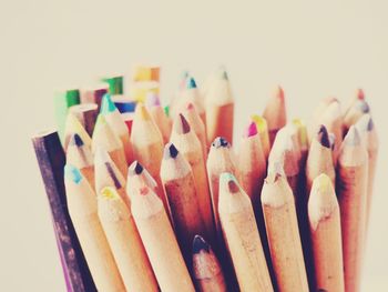 Close-up of colored pencils against white background