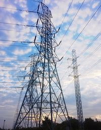 Low angle view of electricity pylon against sky