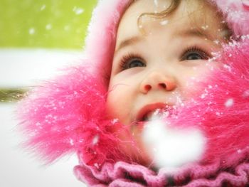 Close-up of woman holding pink flower