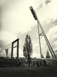 Windmill on field against cloudy sky