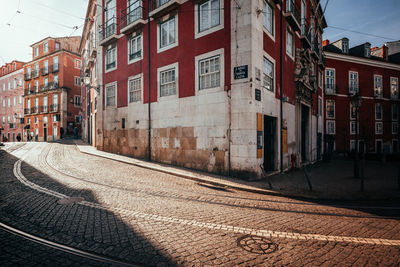 Railroad tracks amidst buildings in city