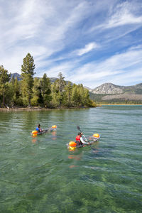 A man and woman kayaking on lake tahoe, ca