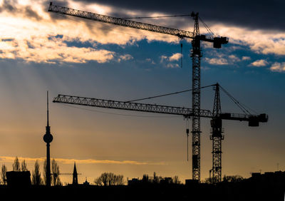 Silhouette tower against sky during sunset