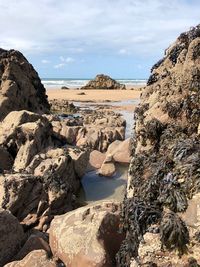 Panoramic view of rocks and sea against sky