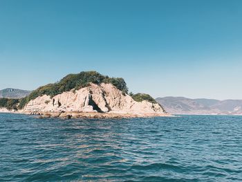 Scenic view of sea against clear blue sky