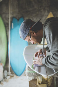 Surfboard shaper refining a new design