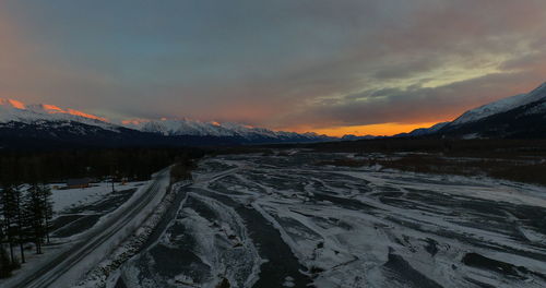 Scenic view of snowcapped mountains against sky during sunset