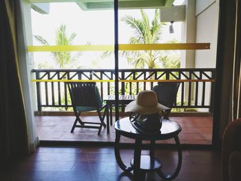 Man sitting on table by window