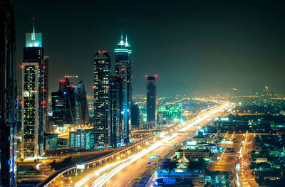 Aerial view of illuminated buildings in city at night