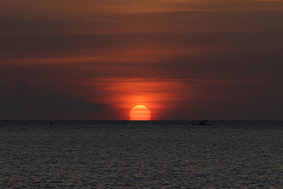 Scenic view of sea against orange sky