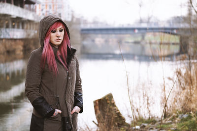 Portrait of young woman standing on shore