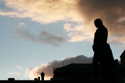 Low angle view of silhouette statue against sky