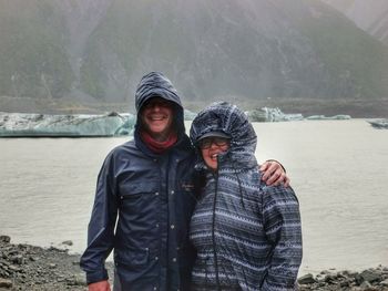 Couple standing on lakeshore