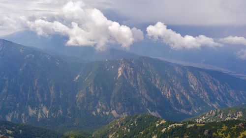 Scenic view of mountains against cloudy sky