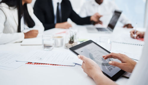 Midsection of business colleagues working at office