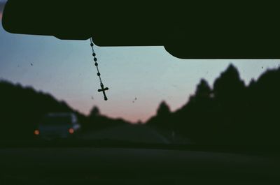 Cross on rear view mirror