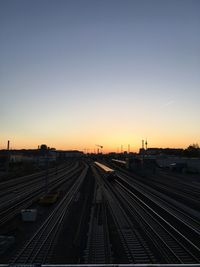 High angle view of railroad tracks against clear sky during sunset