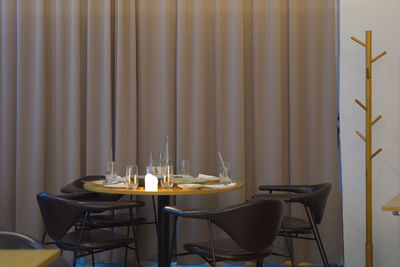 Empty chairs and table against wall at home