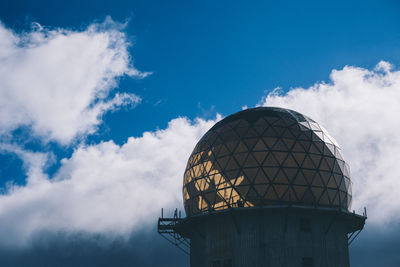 Low angle view of communications tower against sky