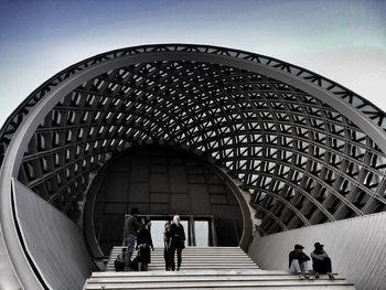 People relaxing at modern building