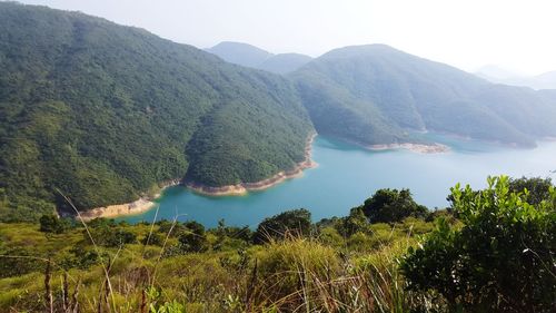 High angle view of lake and mountains against clear sky