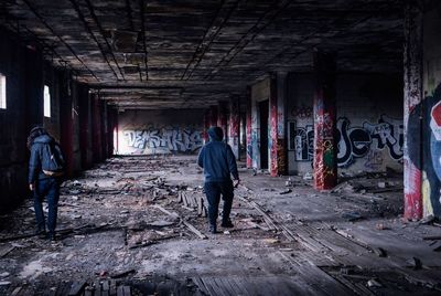 Rear view of man standing in abandoned building