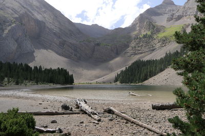 Scenic view of lake and mountains against cloudy sky