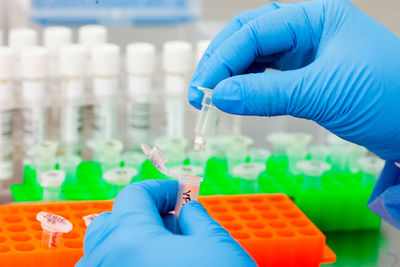 Scientist hands while extracting dna using the spin column-based nucleic acid purification technique