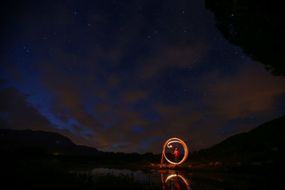 Light painting against sky at night