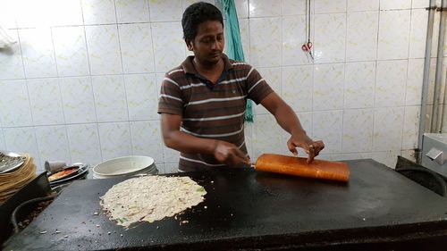 Mid adult man preparing food in kitchen