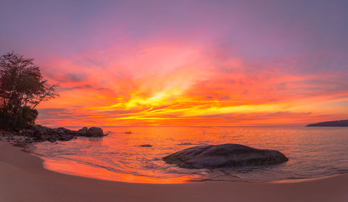 Scenic view of sea against romantic sky at sunset