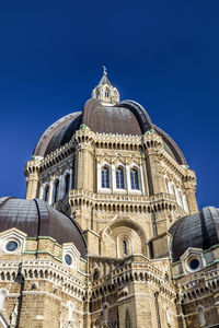 Low angle view of building against blue sky