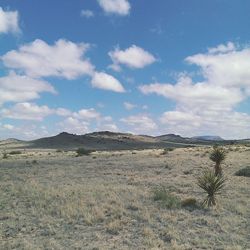 Scenic view of landscape against cloudy sky