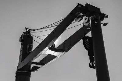 Low angle view of crane against clear sky